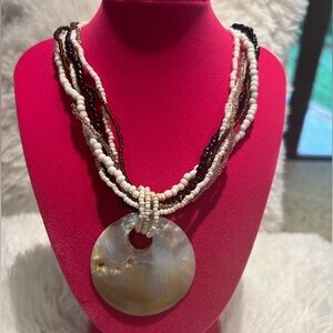 Vintage Chic Multi-Strand Shell Pendant Necklace with mother of pearl.